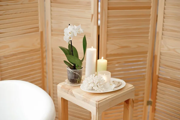 set for spa procedure and bathroom procedures, burning candles and flower