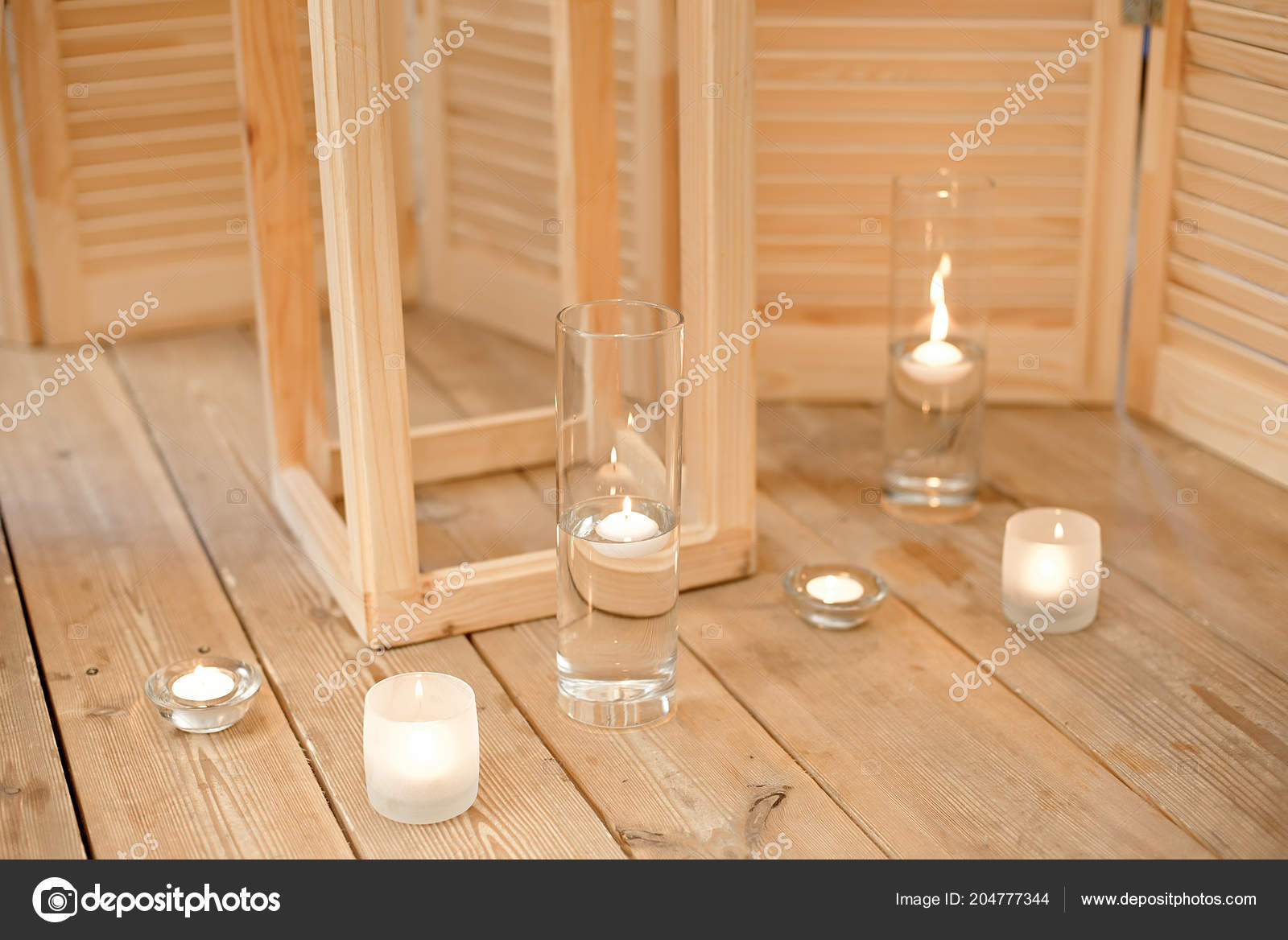 Set For Spa Procedure Near Bathtub With Towels Burning Candles And