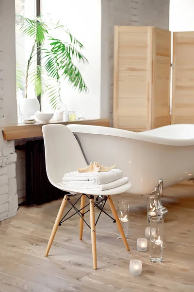 Instellen voor de procedure van de spa in de buurt van bad met handdoeken, brandende kaarsen en accessoires — Stockfoto