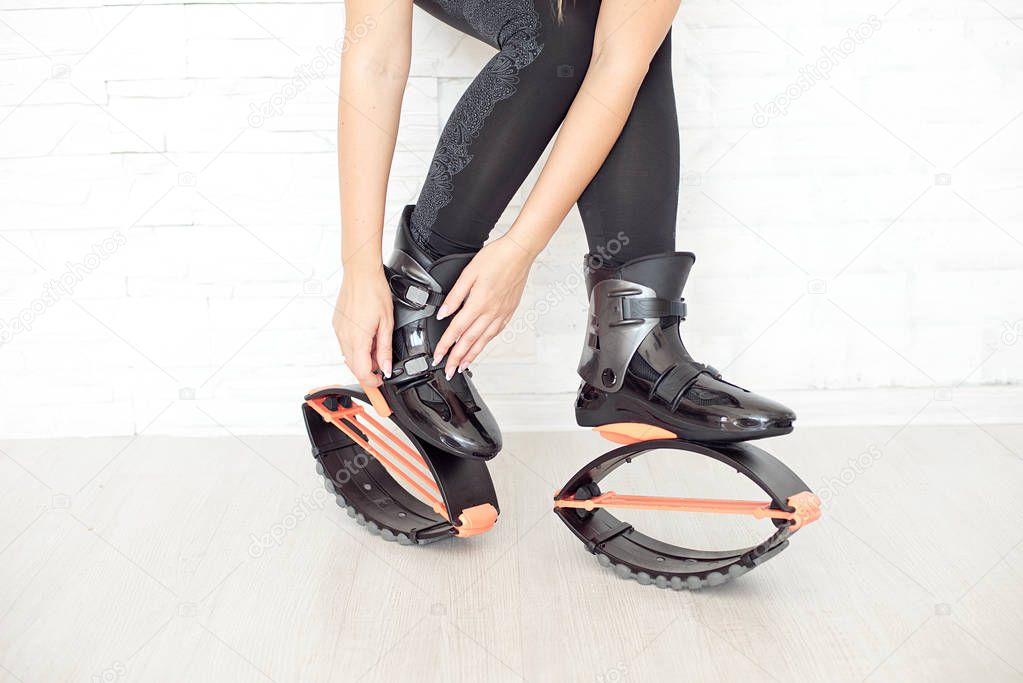 close-up of female legs in kangoo jumps boots indoors 