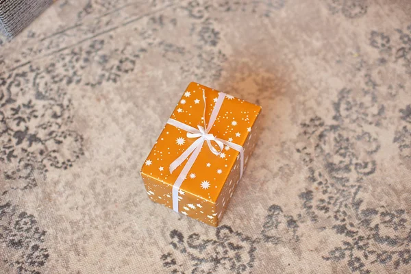 Gift box on white background. Present in craft and colored paper decorated with white satin ribbon bows. Christmas and other holidays concept.