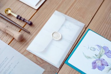 Natürmort düğün davetiye zarfları ve dantel kartları hat aletleri ve dekor ahşap zemin üzerinde