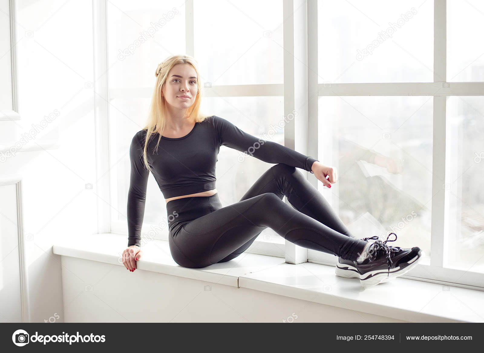 Young slim woman with an athletic body blonde hair wearing in
