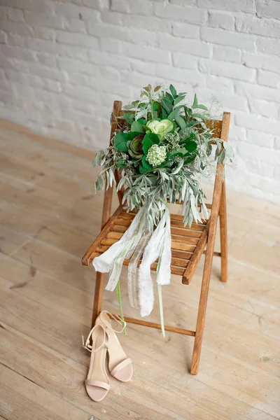 Wedding brides wedding accessories. Flower ,shoes and chair.