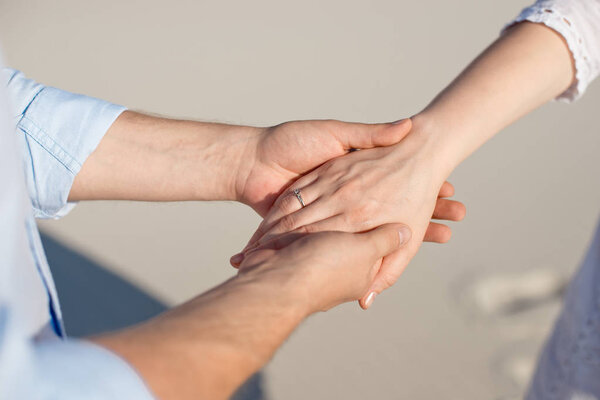 Close-up man and woman hand touching holding together on blurred background for love and healing concept.