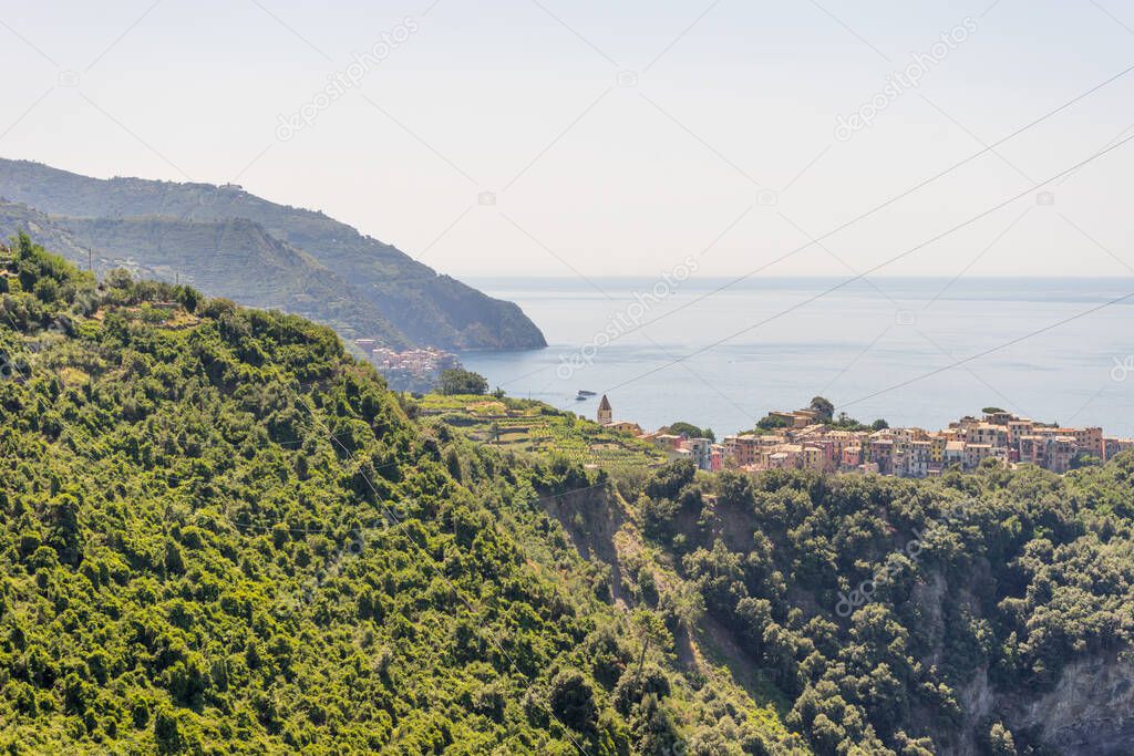 Europe, Italy, Cinque Terre, Corniglia, a body of water with a mountain in the background