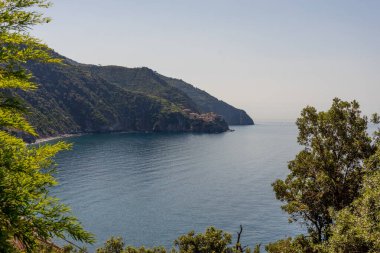 Europe, Italy, Cinque Terre, Corniglia, a large body of water surrounded by trees clipart