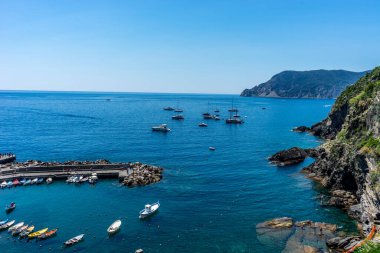 Vernazza, Cinque Terre, Italy - 27 June 2018: Boats docked near the shore at Vernazza, Cinque Terre, Italy clipart