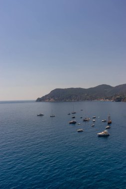 Vernazza, Cinque Terre, Italy - 27 June 2018: Boats docked near the shore at Vernazza, Cinque Terre, Italy clipart