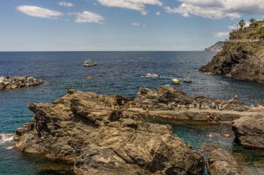Manarola, Cinque Terre, İtalya - 26 Haziran 2018: Manarola, Cinque Terre, İtalya 'da plaj ve güneşin tadını çıkaran turistler