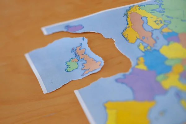 a torn paper map symbolizing the UK leaving the European Union or Brexit