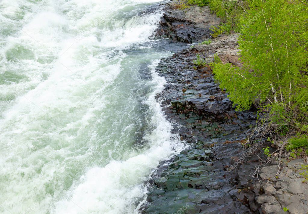 The Spokane river in spring flood near downtown Spokane, Washington