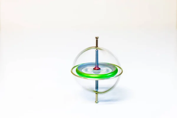 A spinning toy gyroscope isolated on a white background — Stock Photo, Image