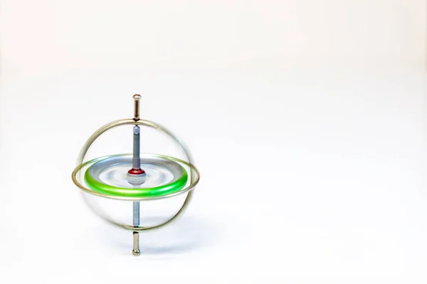 A spinning toy gyroscope isolated on a white background — Stock Photo, Image