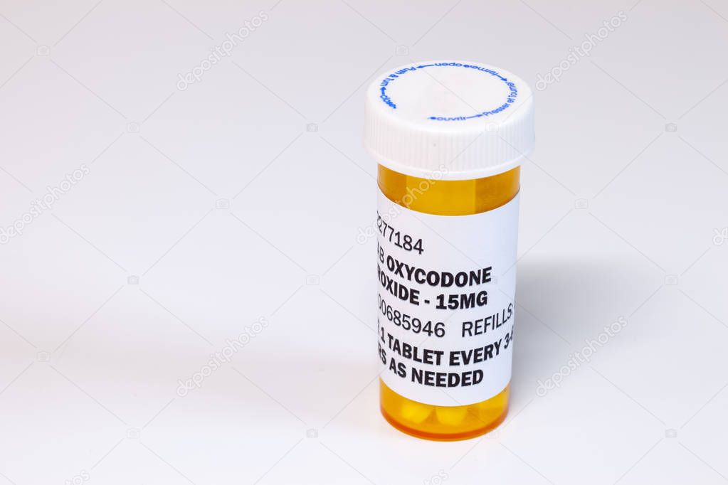 Prescription bottle with Oxycodone tablets isolated on a white background. Oxycodone is a generic prescription opioid.