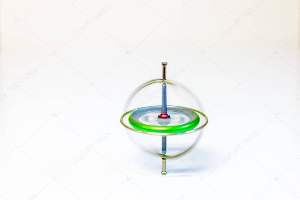 A spinning toy gyroscope isolated on a white background