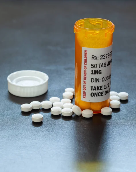 Prescription bottle with backlit generic tablets or pills.