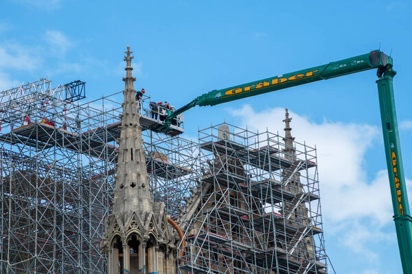 Paris, France - June 16 2020: Workers begin to dismantle Notre Dame de Paris cathedral scaffolding, 14 months after the fire