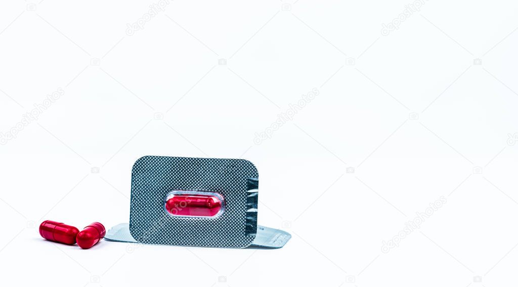 Fluconazole 150 mg. Antifungal drug for treatment acute or recurrent vaginal candidiasis. Red capsule pills in blister pack isolated on white background with copy space. Vaginal itching concept. 