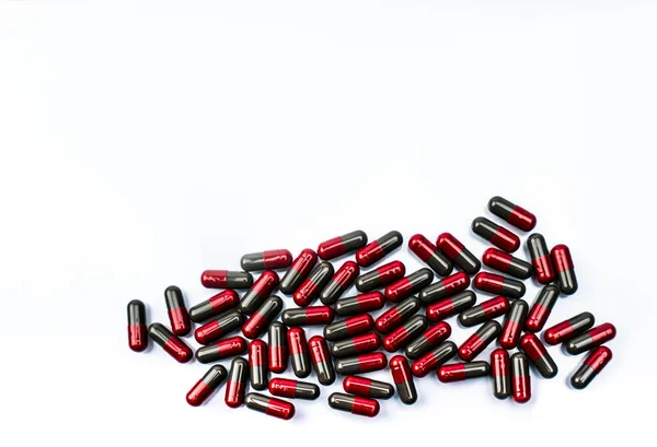 赤とグレーのカプセル錠剤をコピー スペースと白い背景で隔離のパイルでトップ表示 フルナリジン 片頭痛予防治療薬 グローバルなヘルスケアの概念 医薬品業界 — ストック写真