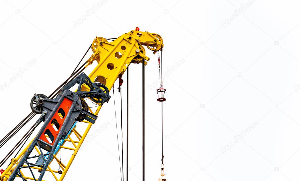 Big yellow construction crane for heavy lifting isolated on white background. Construction industry. crane for container lift or at construction site. Crane rental business concept. Crane dealership.