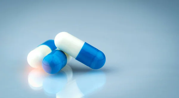 Blå och vit kapsel piller på gradient bakgrund. Globala sjukvårds konceptet. Antibiotika läkemedelsresistens. Antimikrobiella kapsel piller. Läkemedelsindustrin. Apoteksprodukter. Läkemedelsmarknaden. — Stockfoto