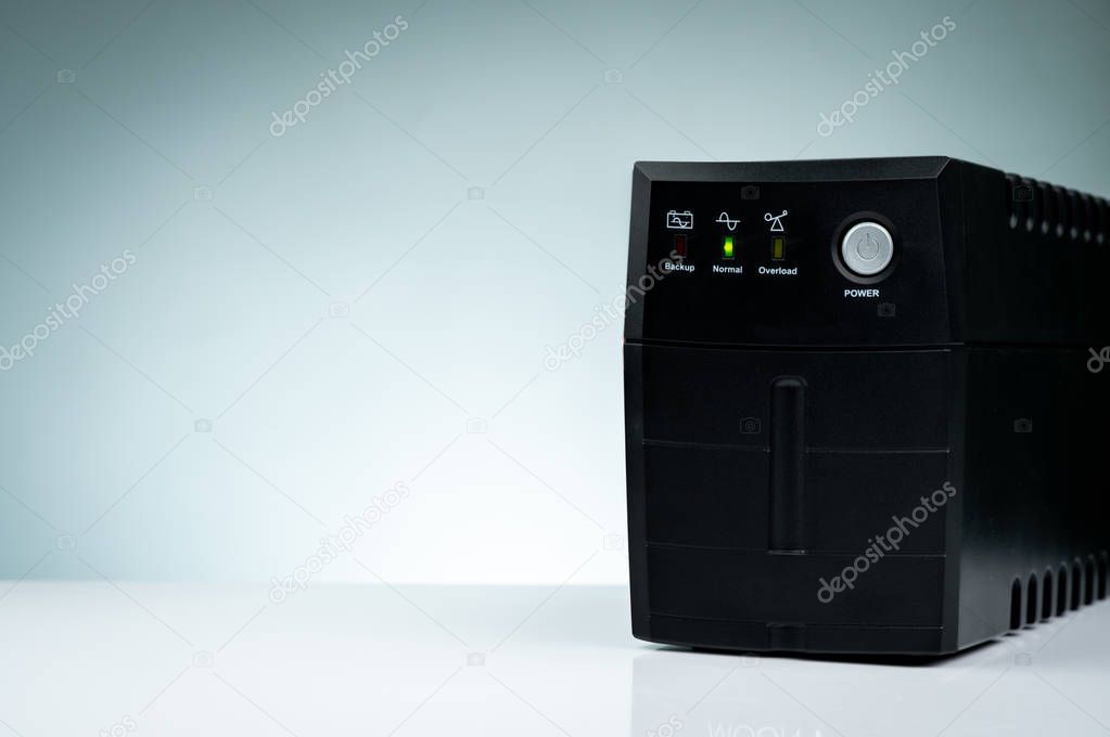 Uninterruptible power supply. Backup Power UPS with battery isolated on table. UPS for PC. Equipment for computer system at office for security. Power protection solutions from home to data center.