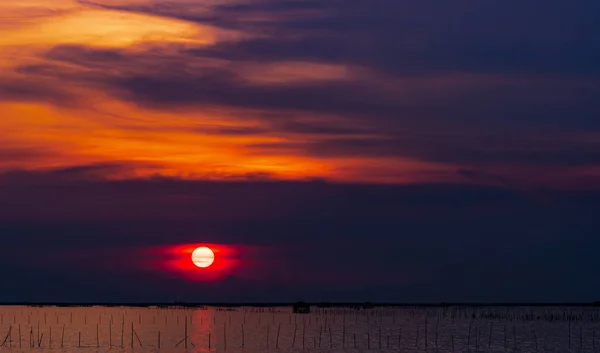 Belo pôr-do-sol sobre o mar. Céu escuro vermelho e laranja por do sol e nuvens. Fundo da natureza para um conceito tranquilo e pacífico. Pôr do sol em Chonburi, Tailândia. Grande sol emocional ao entardecer. Céu crepúsculo . — Fotografia de Stock