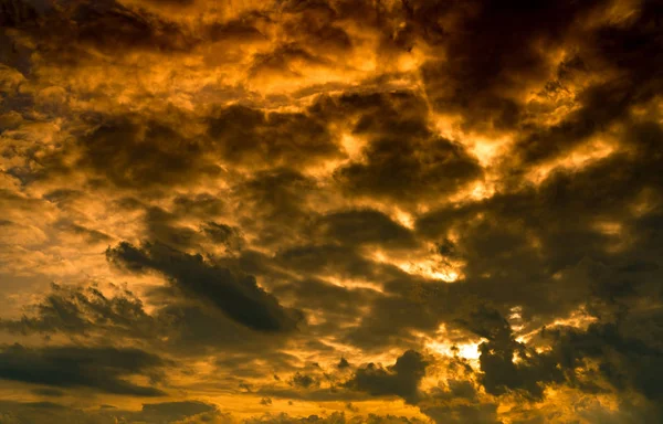 Dramatic golden sunset sky and white cumulus clouds. Cloudy sky. God light concept. Beautiful cloudscape. Peaceful and tranquil concept. Nature abstract background. Beauty in nature. Climate change.