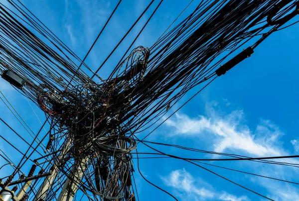 Tangled electrical wires on urban electric pole. Disorganized and messy to organization management concept. Tangled electrical wires should take underground wire for beautiful landscape.