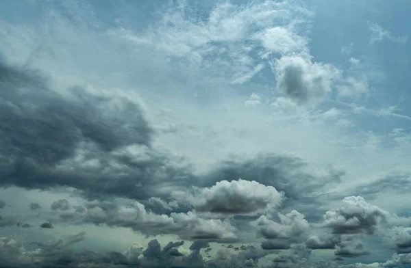 Blue sky and dark cumulus clouds. Cloudscape. Blue sky and fluffy clouds. The storm sky before raining. Rain clouds. Beauty in nature. Nature background. Tranquil, peaceful, and freedom background.