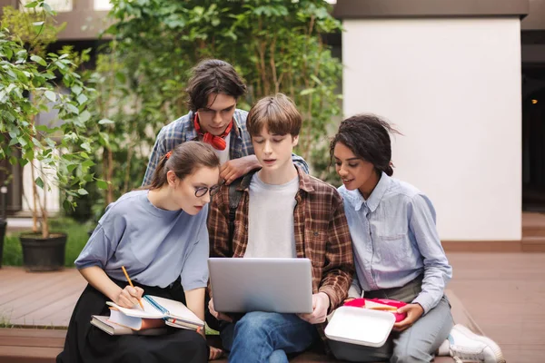 Group Young Students Sitting Bench Books Laptop Knees Studying Together — Stock Photo, Image