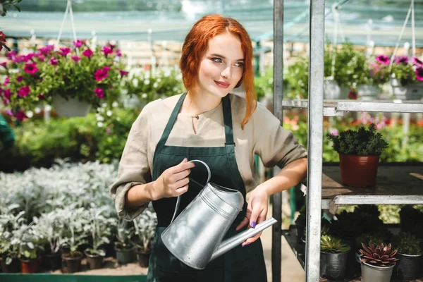 Beautiful Smiling Florist Apron Standing Watering Can Hands Dreamily Looking — Stock Photo, Image