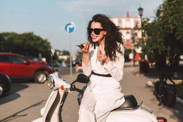 Young Woman Dark Curly Hair White Costume Sunglasses Sitting White — Stock Photo, Image