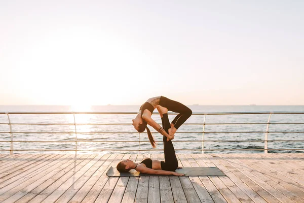 Foto Duas Belas Senhoras Tops Esportivos Pretos Leggings Formação Ioga — Fotografia de Stock