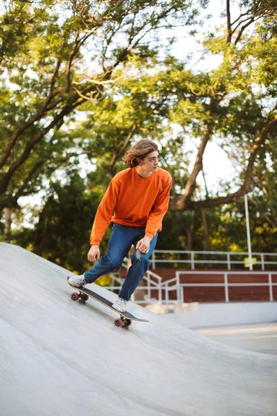 Νεαρός Άντρας Πορτοκαλί Πουλόβερ Skateboard Και Ενεργεία Ακροβατικά Που Αφιερώνουν — Φωτογραφία Αρχείου