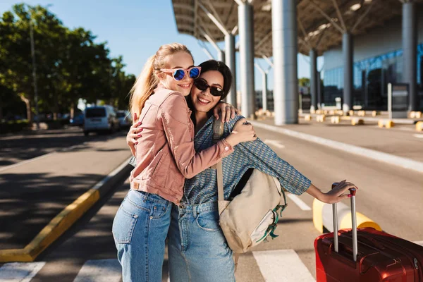 Two Beautiful Girls Sunglasses Happily Hugging Each Other Looking Camera — Stock Photo, Image