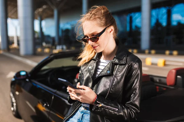Smiling Girl Sunglasses Skin Jacket Leaning Black Cabriolet Car Dreamily — Stok Foto