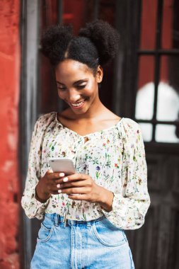 Güzel gülümseyen kız mutlu istimal cellphone açık bluz