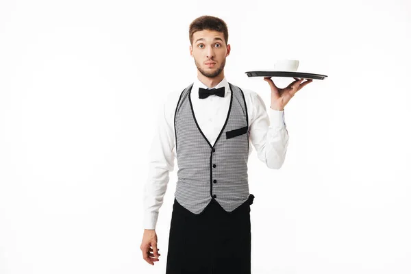 Young Shocked Waiter Uniform Holding Tray Cup Coffee Amazedly Looking — Stock Photo, Image