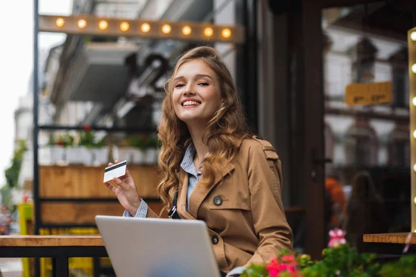 Young Joyful Woman Trench Coat Happily Looking Camera Holding Credit — Stock Photo, Image