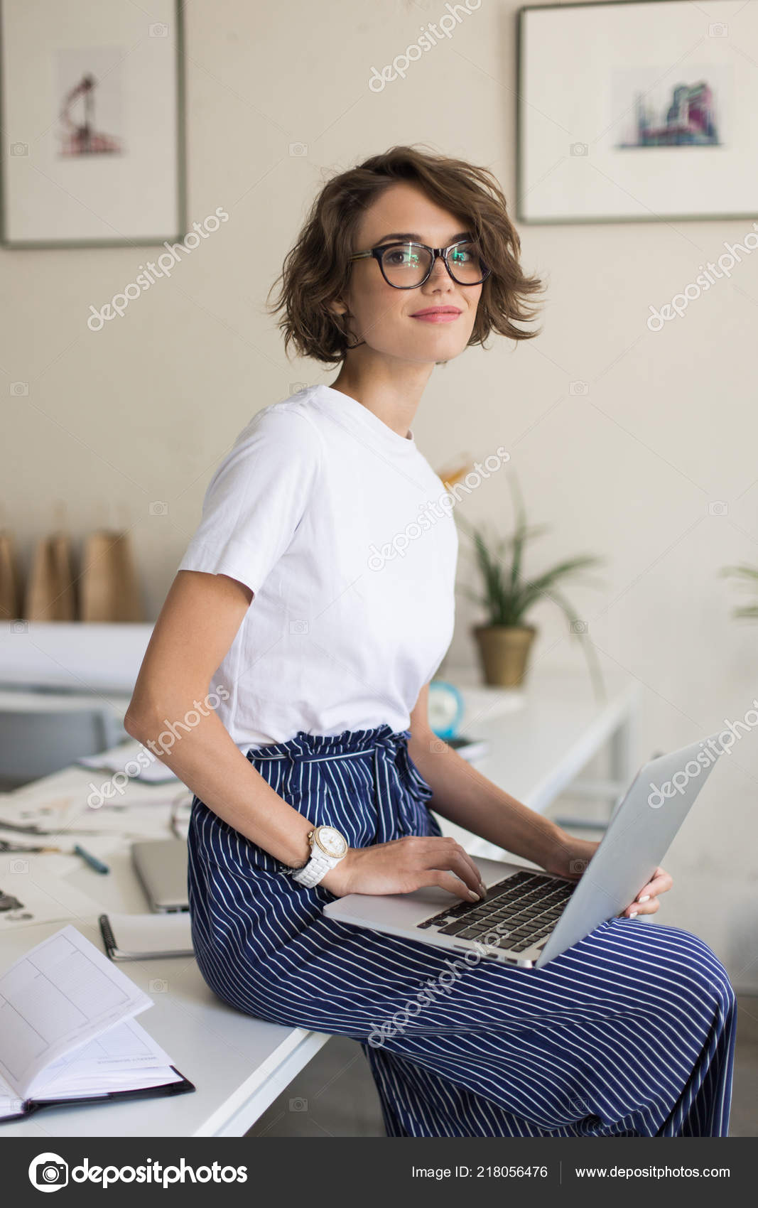 Beautiful Girl Short Curly Hair Eyeglasses White Shirt Sitting Desk Stock  Photo by ©Garetsworkshop 218056476