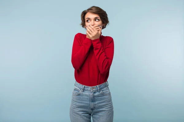 Young Woman Dark Short Hair Red Sweater Jeans Covering Mouth — Stock Photo, Image