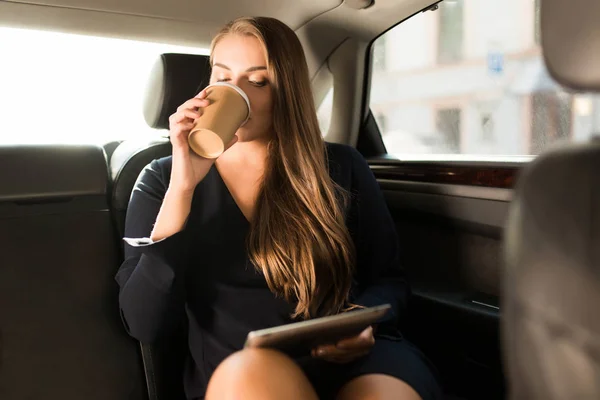 Young Attractive Businesswoman Black Dress Sitting Back Seat Car Tablet — Stockfoto