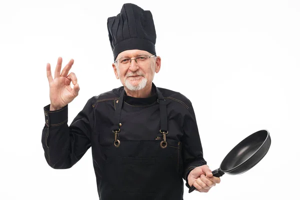 검은 앞치마와 모자 지주에 회색 수염과 오래 된 잘생긴 남자 — 스톡 사진