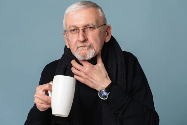 Old sick man with gray hair and beard in eyeglasses and scarf wi