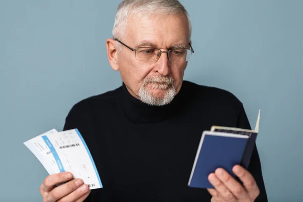 Old pensive man with gray hair and beard in eyeglasses and sweat