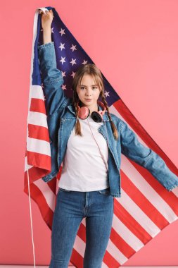 Young attractive girl with two braids in denim jacket and jeans 