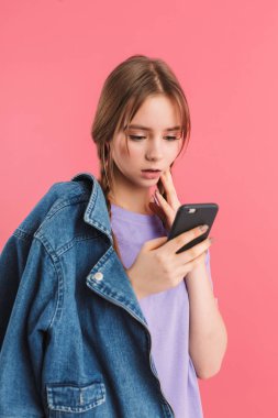 Young attractive girl with two braids in lilac t shirt and denim