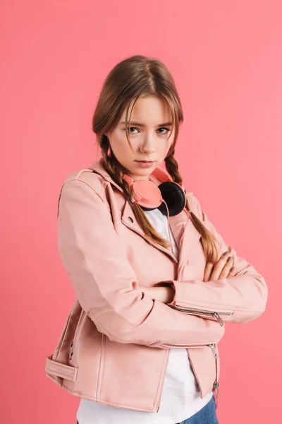 Young upset girl with two braids in leather jacket with headphon — Stok fotoğraf